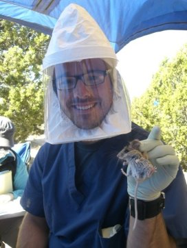 Craig Gritzen doing fieldwork in the Great Basin Desert, in Juab County Utah, 2009. Working with the "Sin Nombre Virus" requires the use of specialized headgear to prevent human infection.