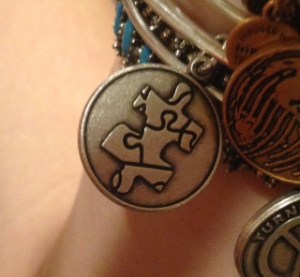 This charm bracelet features the symbol for autism awareness. Baker wears it every day.