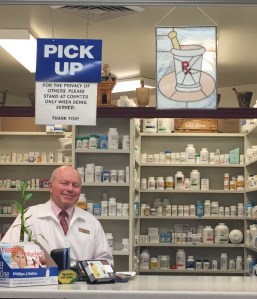 Lloyd Thomas stands at his pharmacy in Roy Winegars.